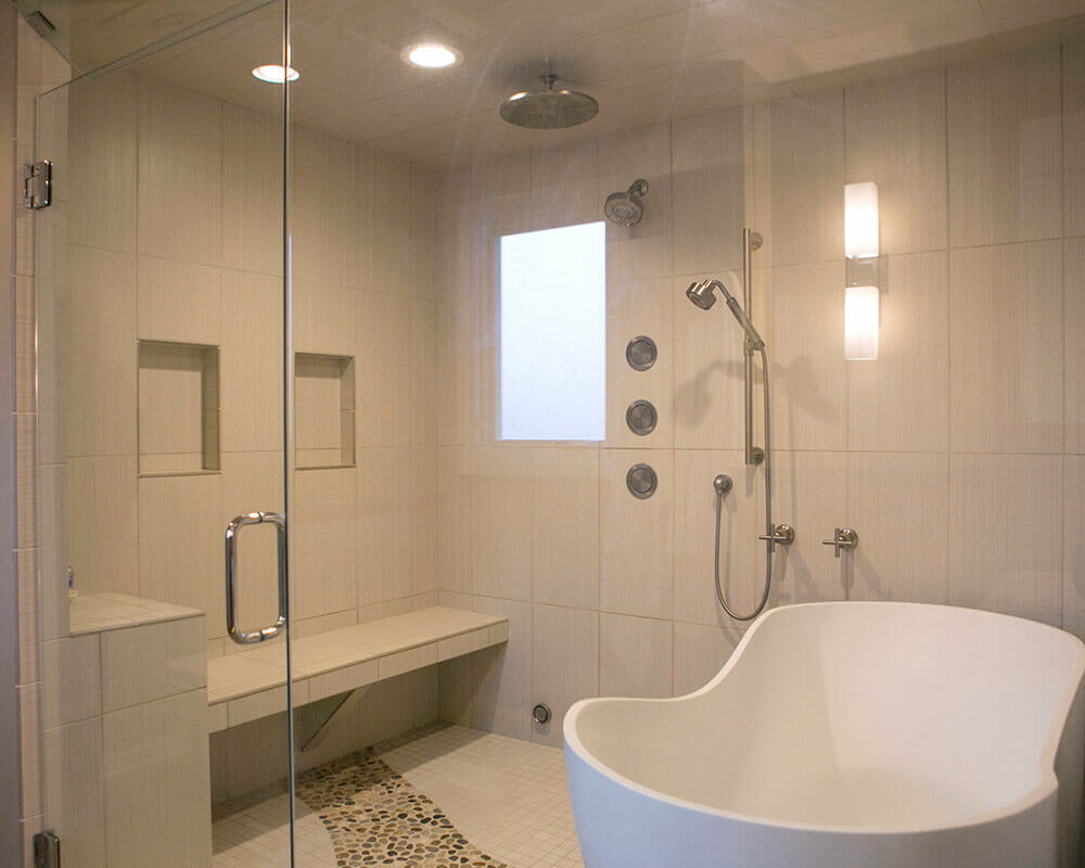 Custom bathroom remodel using locally sourced river rocks, custom tile, Kohler fixtures, and steam shower in Madison, Wisconsin by TDS Design Build.