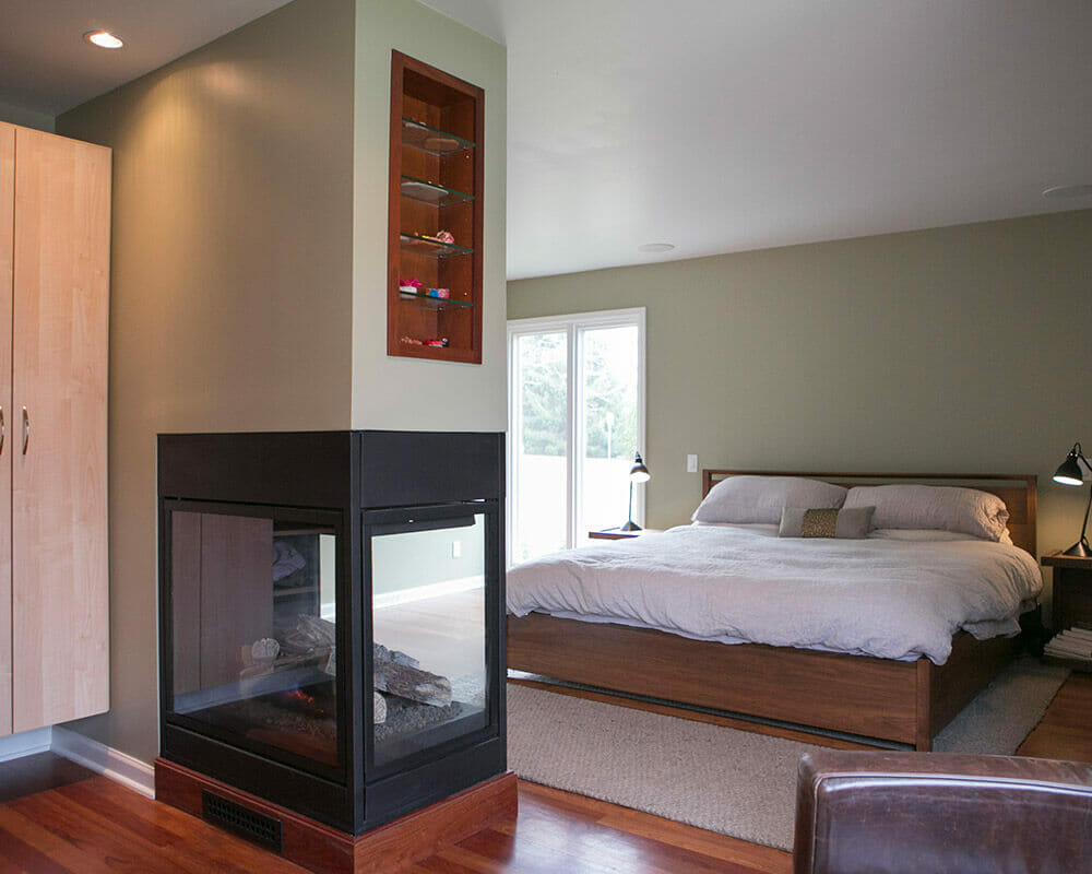 Primary suite with custom bathroom remodel, 3 sided fireplace, and walk-in primary closet by TDS Design Build.