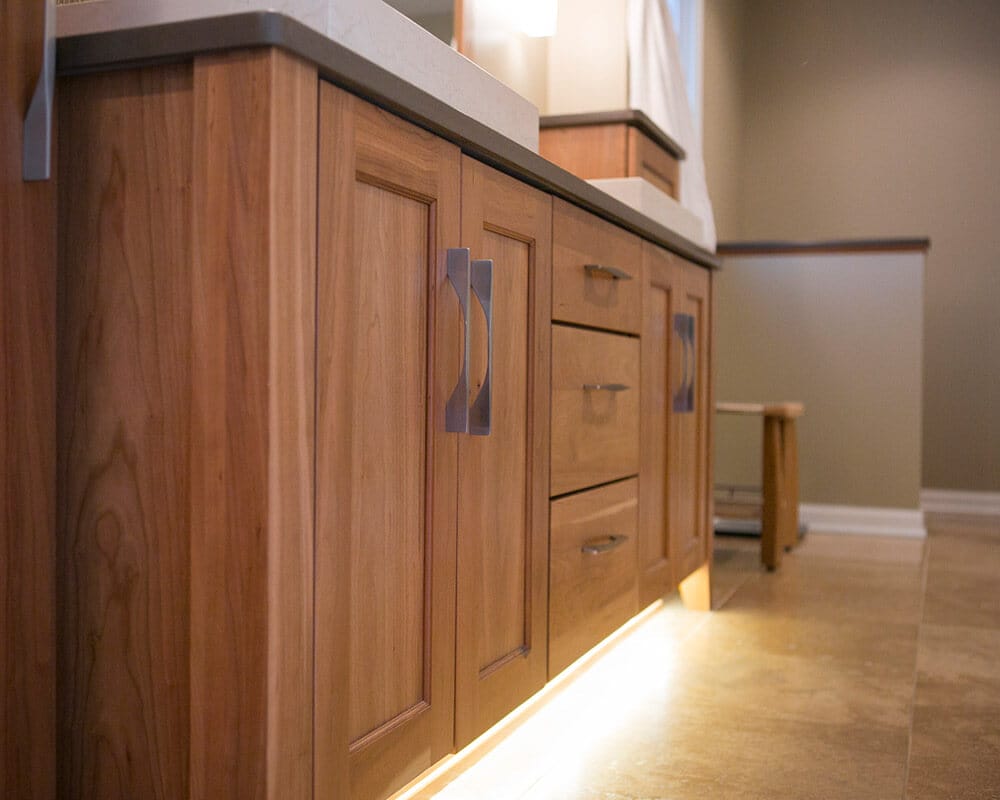 Custom bathroom remodel using Woodharbor custom cherry cabinetry and quartz countertops in Madison, Wisconsin by TDS Design Build.