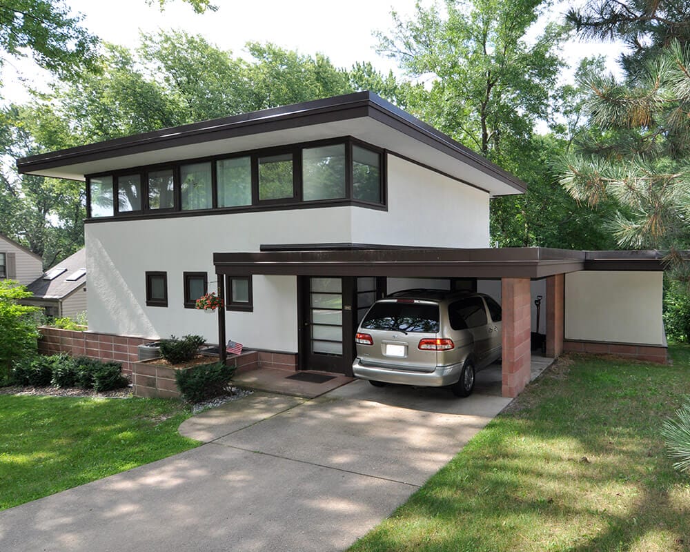 Exterior remodeling and home addition included stucco work, brick work, painting, new windows, and a new rubber roof by TDS Design Build.