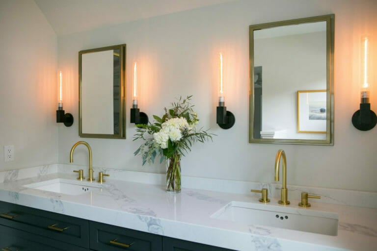 Engineered quartz countertop with modern brass fixtures for a contemporary and sophisticated ensuite bathroom remodel in Maple Bluff, Wisconsin by TDS Design Build.