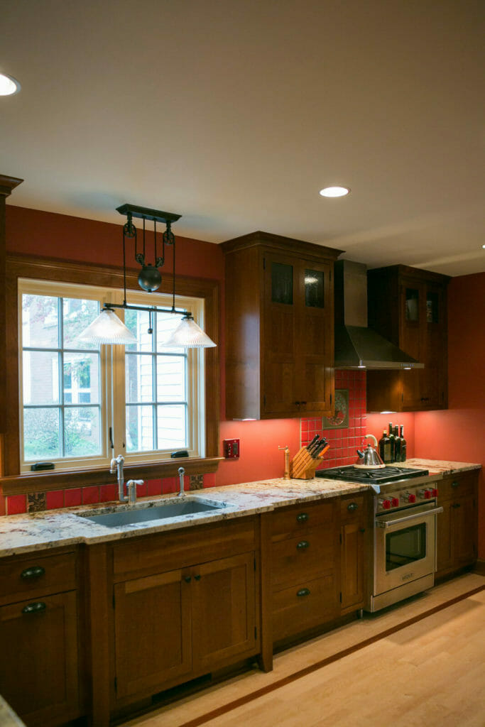 Granite countertops, cherry cabinets, and Brazilian cherry inlay and maple flooring in the kitchen of the historic restoration of a 1922 Frank Riley Colonial Revival home on the Isthmus in Madison, Wisconsin.