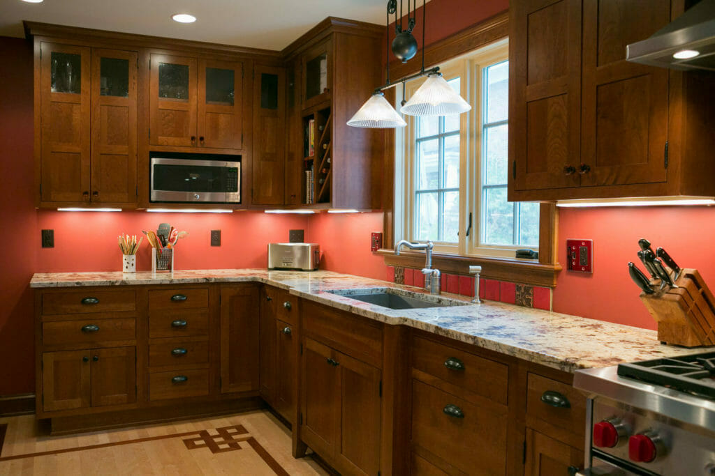 Granite countertops, cherry cabinets, and Brazilian cherry inlay and maple flooring in the kitchen of the historic restoration of a 1922 Frank Riley Colonial Revival home on the Isthmus in Madison, Wisconsin.