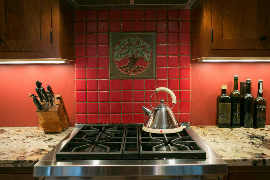 Motawi decorative tile and granite countertops in the kitchen of the historic restoration of a 1922 Frank Riley Colonial Revival home on the Isthmus in Madison, Wisconsin.