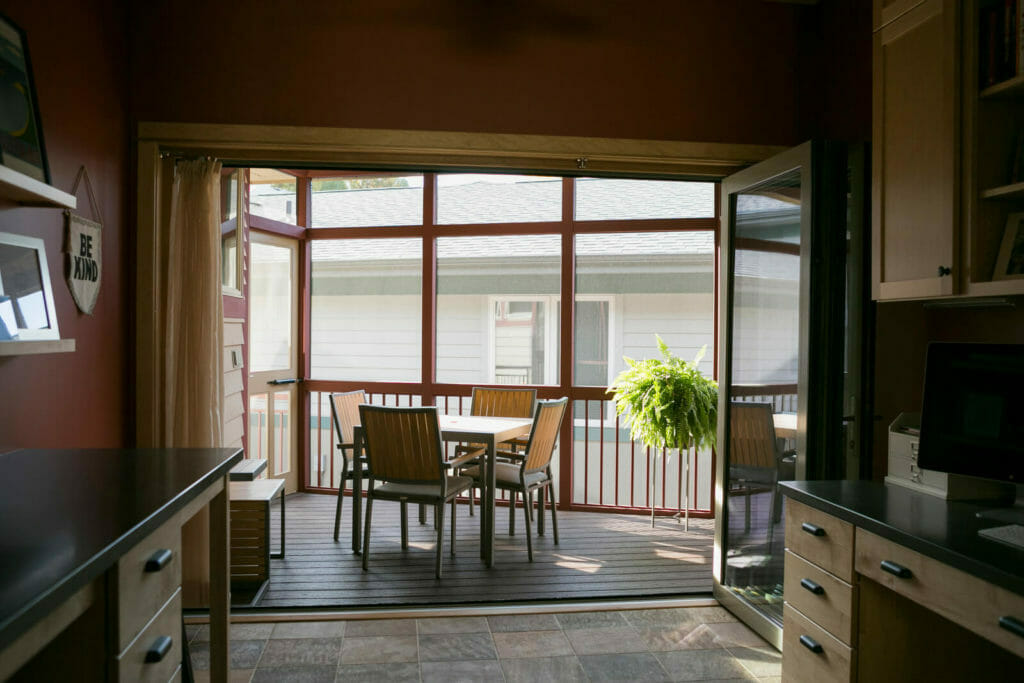 An addition of a screen porch with a full-length accordion door that opens up the family craft room in Middleton, WI by TDS Design Build.