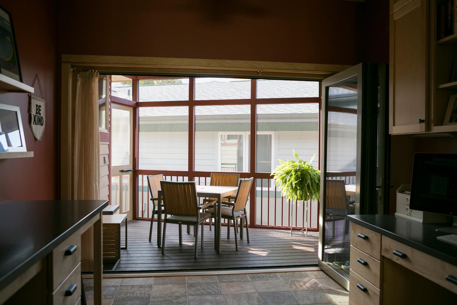 An addition of a screen porch with a full-length accordion door that opens up the family craft room in Middleton, WI by TDS Design Build.