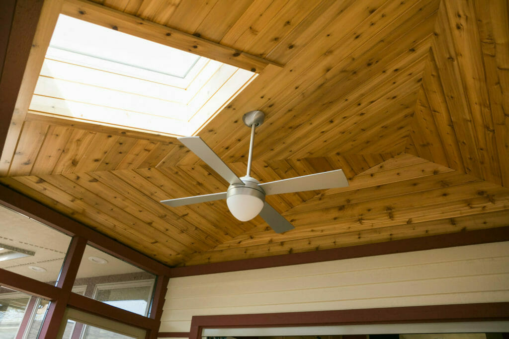 Screen porch with skylight and full-length accordion door that opens up the family craft room in Middleton, WI by TDS Design Build.