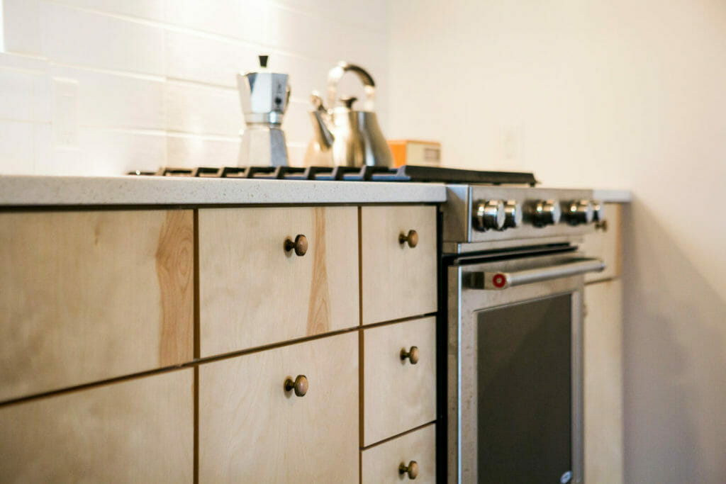 Lofted plywood ceilings, birch cabinets, stainless steel appliances and an open floor plan were part of the new kitchen in this whole house remodel in Monona, Wisconsin by TDS Custom Construction.