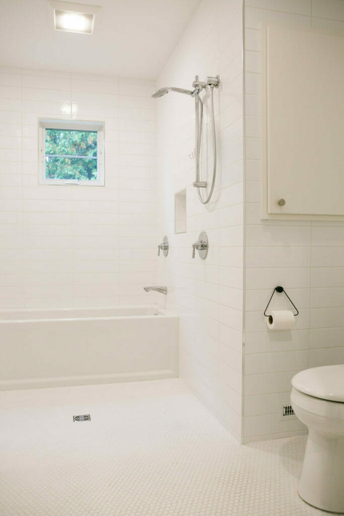 Fresh, clean and modern white bathroom designed with the owners five dogs in mind in a 1,000 square foot whole house remodel in Monona, Wisconsin by TDS Custom Construction.