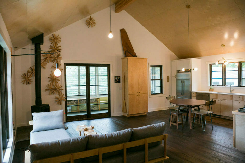 Lofted plywood ceilings, an open floor plan, and reclaimed white oak flooring completed this modern whole house remodel in Monona, Wisconsin by TDS Custom Construction.