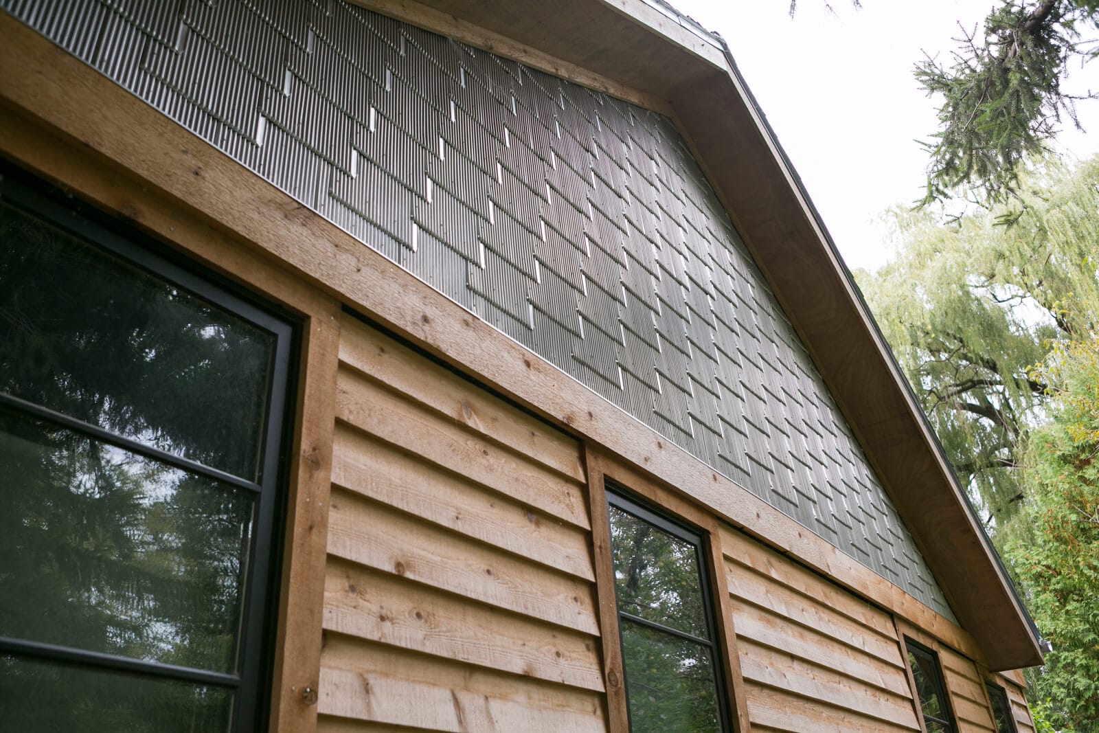 The exterior of this whole home remodel in Maple Bluff, WI by TDS Design Build has Reinke Shake Shingles and cedar siding.