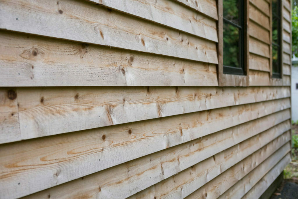 The exterior of this whole home remodel in Monona, WI by TDS Custom Construction has Reinke Shake Shingles and cedar siding.