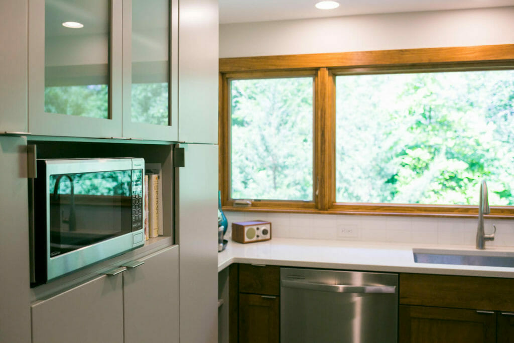 Simple kitchen remodel with Woodharbor walnut lower cabinets and painted upper cabinets installed in a near-west Madison Wisconsin kitchen remodel by TDS Custom Construction.